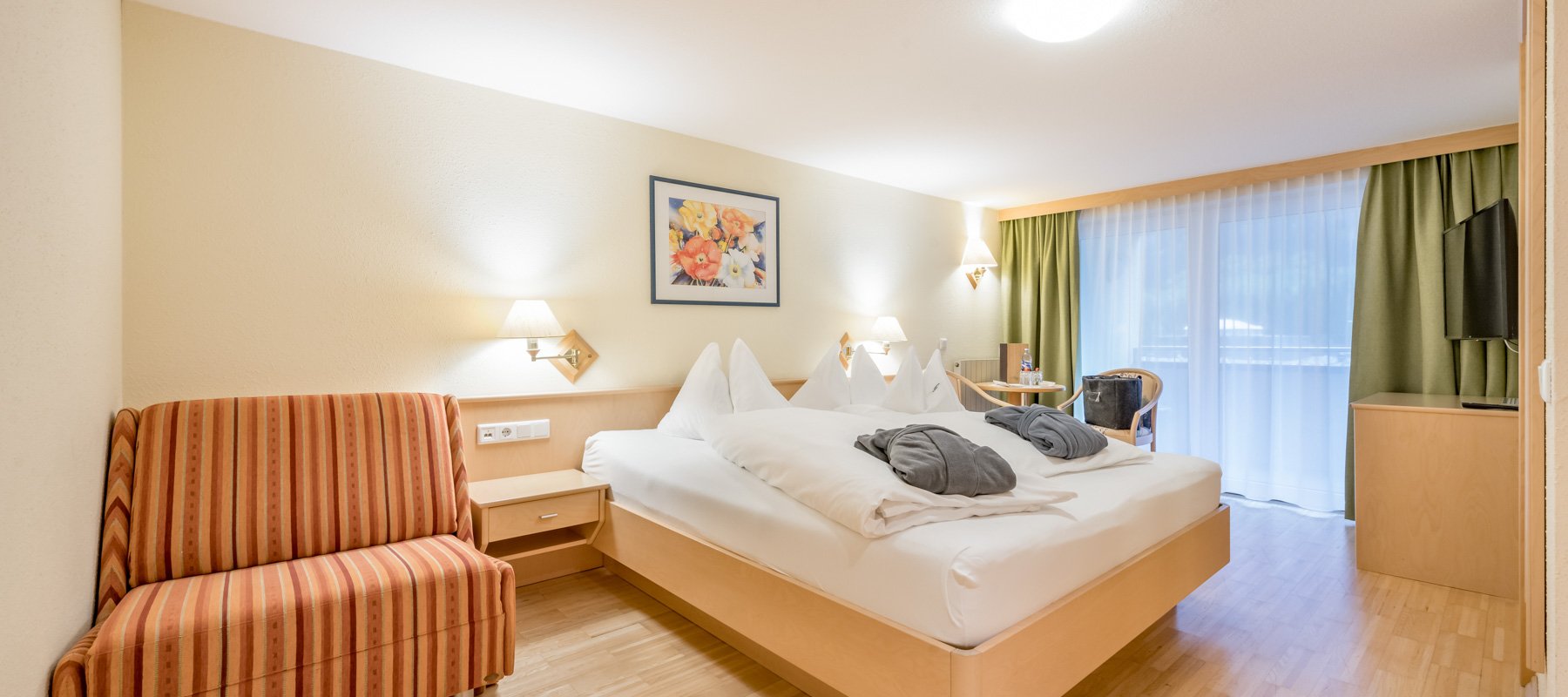 Hotelzimmer mit Doppelbett, Ausziehcouch und Holzeinrichtung